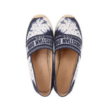 Pair of blue espadrille flats with logo strap and textured canvas top
