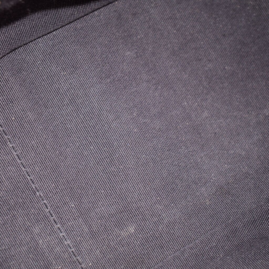 Dark navy quilted leather fabric close-up with fine crosshatch texture
