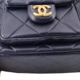 Navy quilted shoulder bag front with gold CC logo snap and top trim