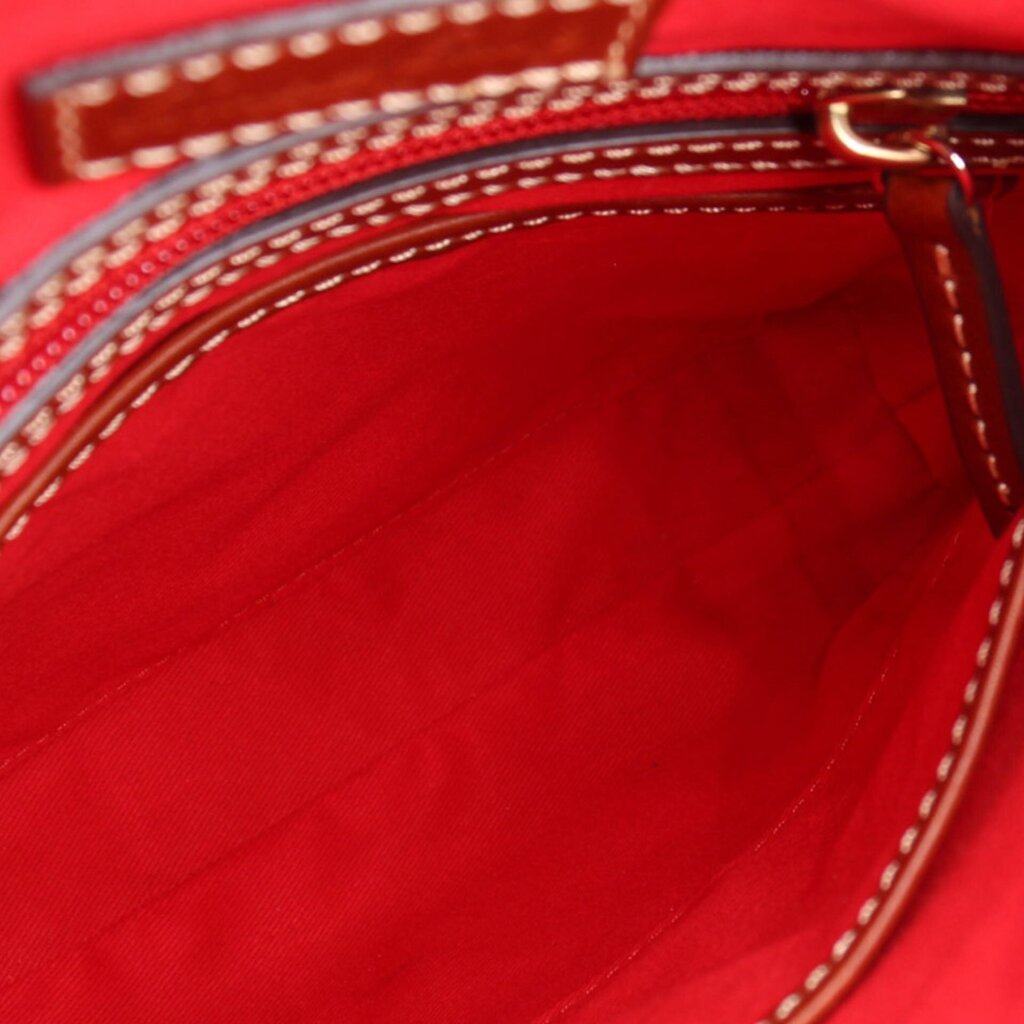 Bag interior with bright red lining and top zipper opening