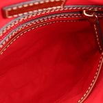 Bag interior with bright red lining and top zipper opening