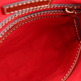 Bag interior with bright red lining and top zipper opening