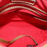 Inside view with red fabric lining and brown piping near the zipper opening