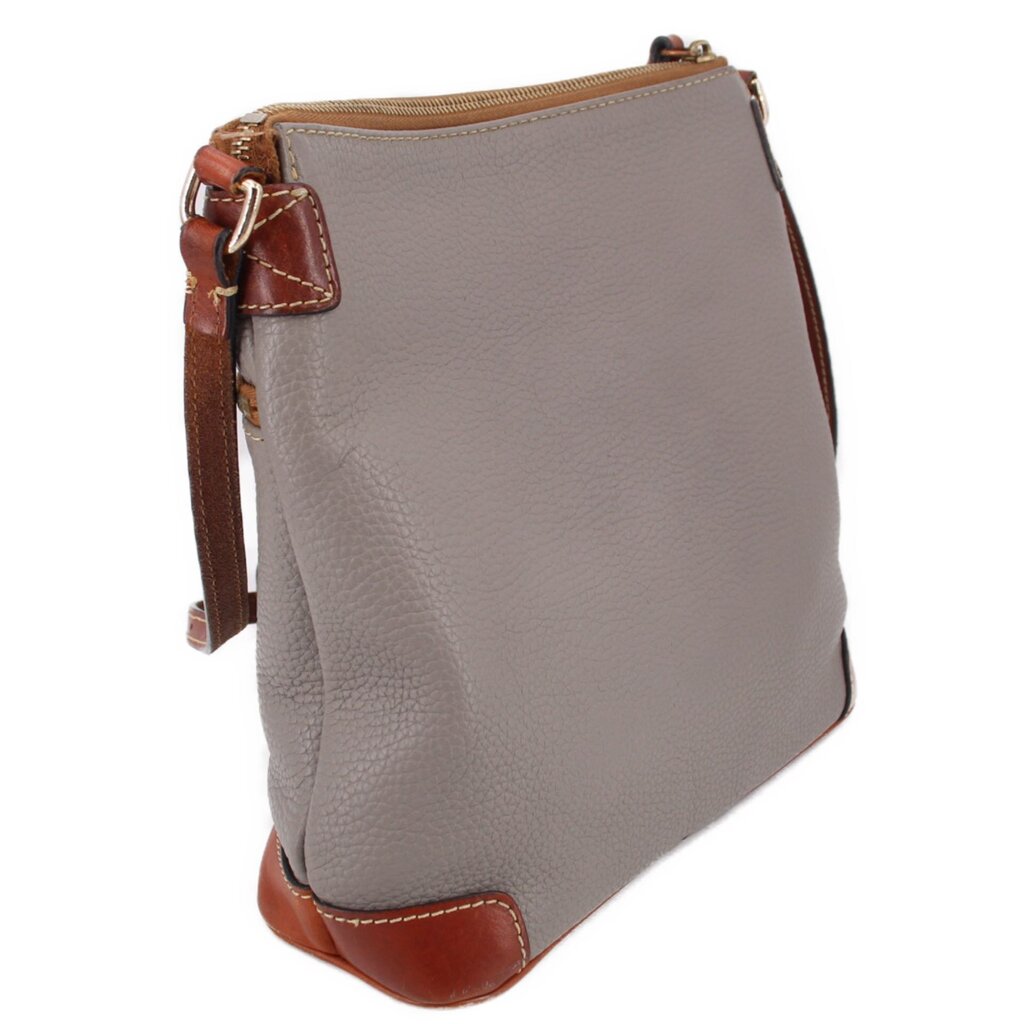 Taupe crossbody with side strap hardware, brown edge trim, and top zip