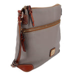 Taupe crossbody bag side view with top zip, brown accents, and braided strap