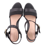 Black ankle-strap sandals with open toe, slingback straps, and gold buckle