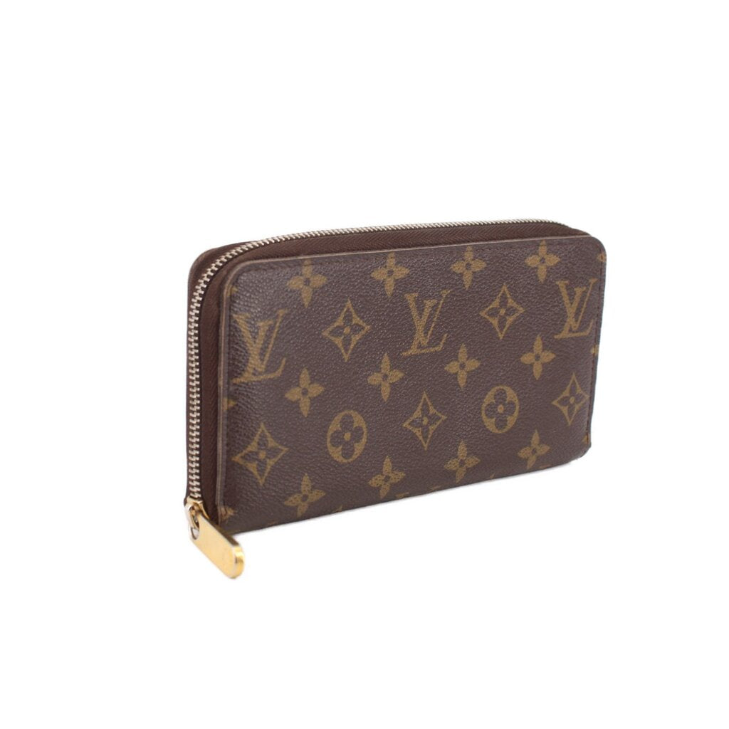 Louis Vuitton Zippy wallet in brown Monogram canvas, side view with zip closure