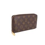 Louis Vuitton Zippy wallet in brown Monogram canvas, side view with zip closure