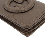 Olive leather Blondie wallet corner close-up with stitched edges and Gucci G emblem