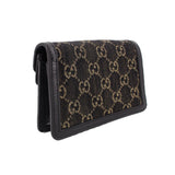Black mini crossbody bag angled view with GG jacquard panel and foldover flap