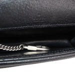 Close-up of silvertone hardware and stitched black leather lining on the mini bag