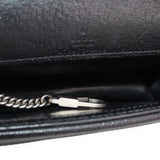 Close-up of silvertone hardware and stitched black leather lining on the mini bag