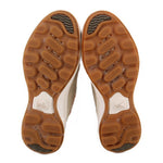 Sneaker outsoles with brown rubber traction tread, Sorel logo on heel