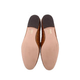 Brown smoking flats showing interior lining and dark heel panels