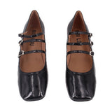 Black patent Mary Jane heels with two strap buckles across the foot and round toe