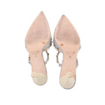 Pair of silver fabric stiletto heels with open back and pointed toe