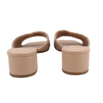 Tan woven slide sandals from the back, block heel and open toe