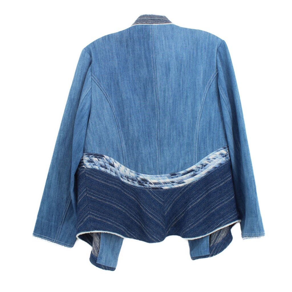 Back view of blue denim jacket with stitched panels and open front