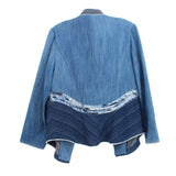 Back view of blue denim jacket with stitched panels and open front
