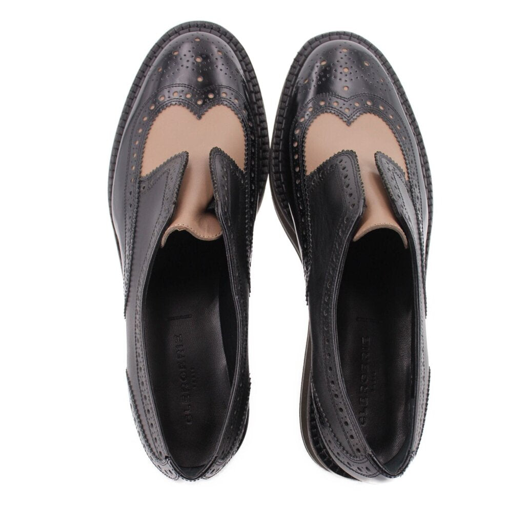 Black leather platform flats, open interior view with brogue wingtip stitching