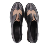 Black leather platform flats, open interior view with brogue wingtip stitching