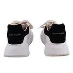 White women's court trainer sneakers with black Alexander McQueen heel pull tab