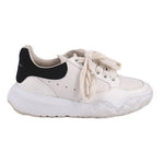 White women's lace-up court trainer sneakers with black heel accent and chunky tread
