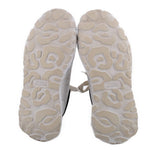 Light beige outsole of women's court trainer sneakers with rugged tread and logo label