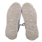 Light beige outsole of women's court trainer sneakers with rugged tread and logo label