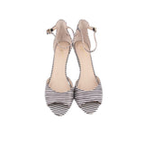 Pair of black-and-white striped heeled sandals with ankle ties and open toe