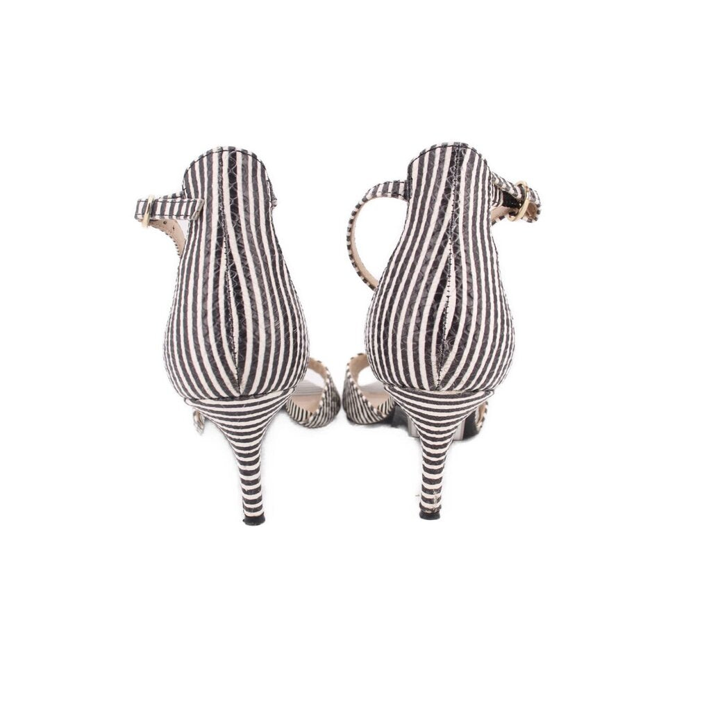 Back view of black-and-white striped heeled sandals with stiletto heel