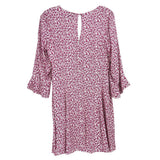 Reformation floral dress in pink with gathered neckline and loose ruffled sleeves