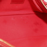 Red crossbody bag interior panel with gold zipper track