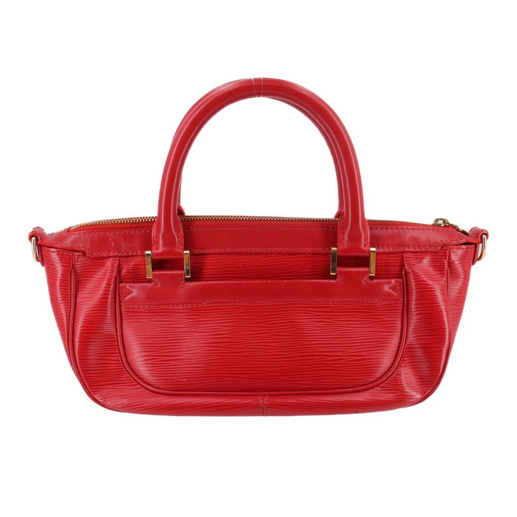 Red DHANURA PM handbag with dual top handles, zip top edge, and front detailing