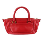 Red DHANURA PM handbag with dual top handles, zip top edge, and front detailing