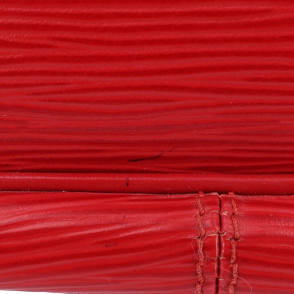 Close-up of red textured leather surface with seam details