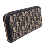 Blue Dior monogram long wallet with curved silhouette, navy trim, and gold-tone zipper.