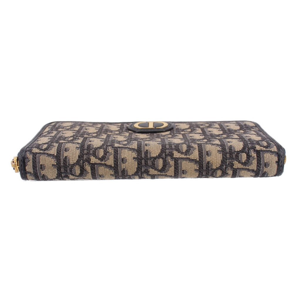 Blue Dior monogram long wallet with gold-tone zipper and centered CD emblem on front.