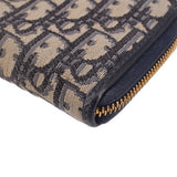 CHRISTIAN DIOR long zip wallet fabric close-up, Dior Oblique pattern with gold zipper