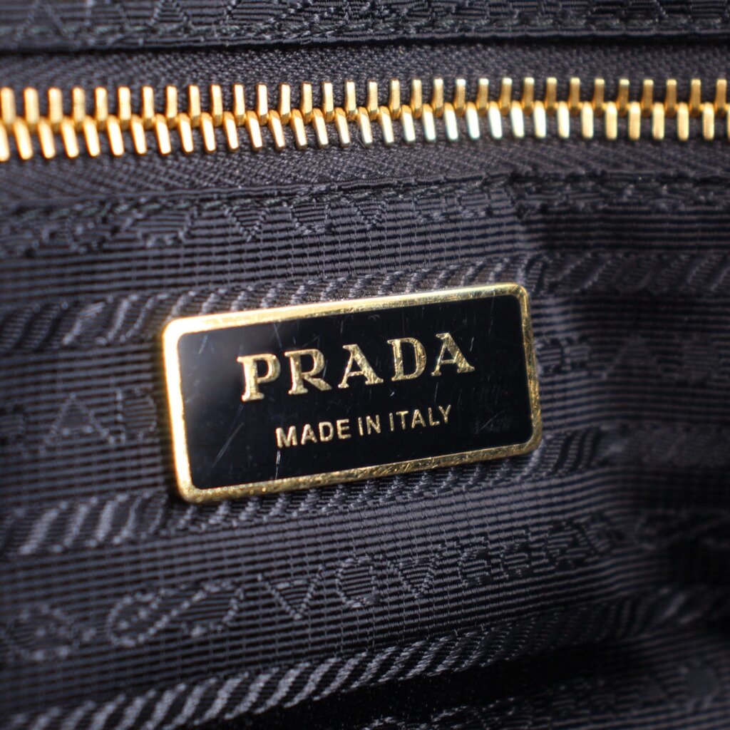 Prada Made in Italy logo tag on black lining with gold zipper detail