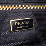Prada Made in Italy logo tag on black lining with gold zipper detail