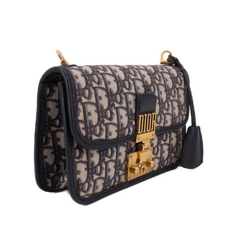 Blue Dior monogram crossbody bag with front flap and gold-tone clasp, side view