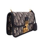 Blue Dior monogram crossbody bag with front flap and gold-tone clasp, side view