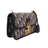 Blue Dior monogram crossbody bag with front flap and gold-tone clasp, side view
