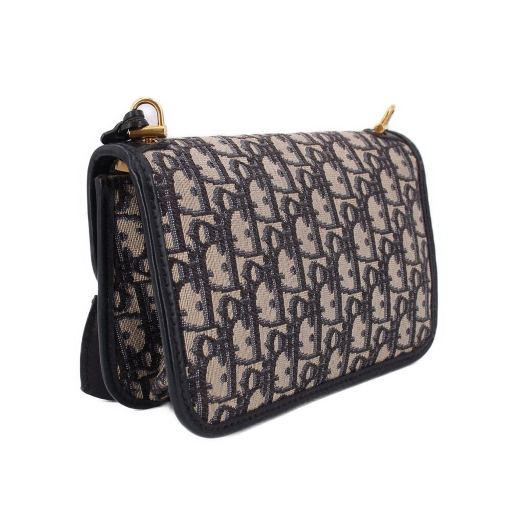 Blue Dior monogram crossbody bag with flap, black edging, and side strap