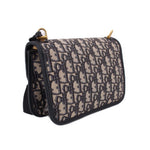 Blue Dior monogram crossbody bag with flap, black edging, and side strap