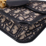 Close-up of blue Dior monogram crossbody bag corner with black leather trim