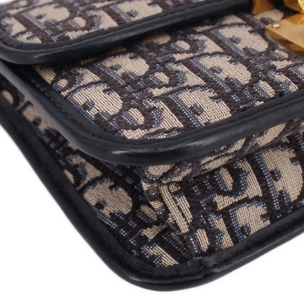 Blue Dior monogram crossbody bag edge close-up with black piping