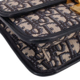 Blue Dior monogram crossbody bag edge close-up with black piping
