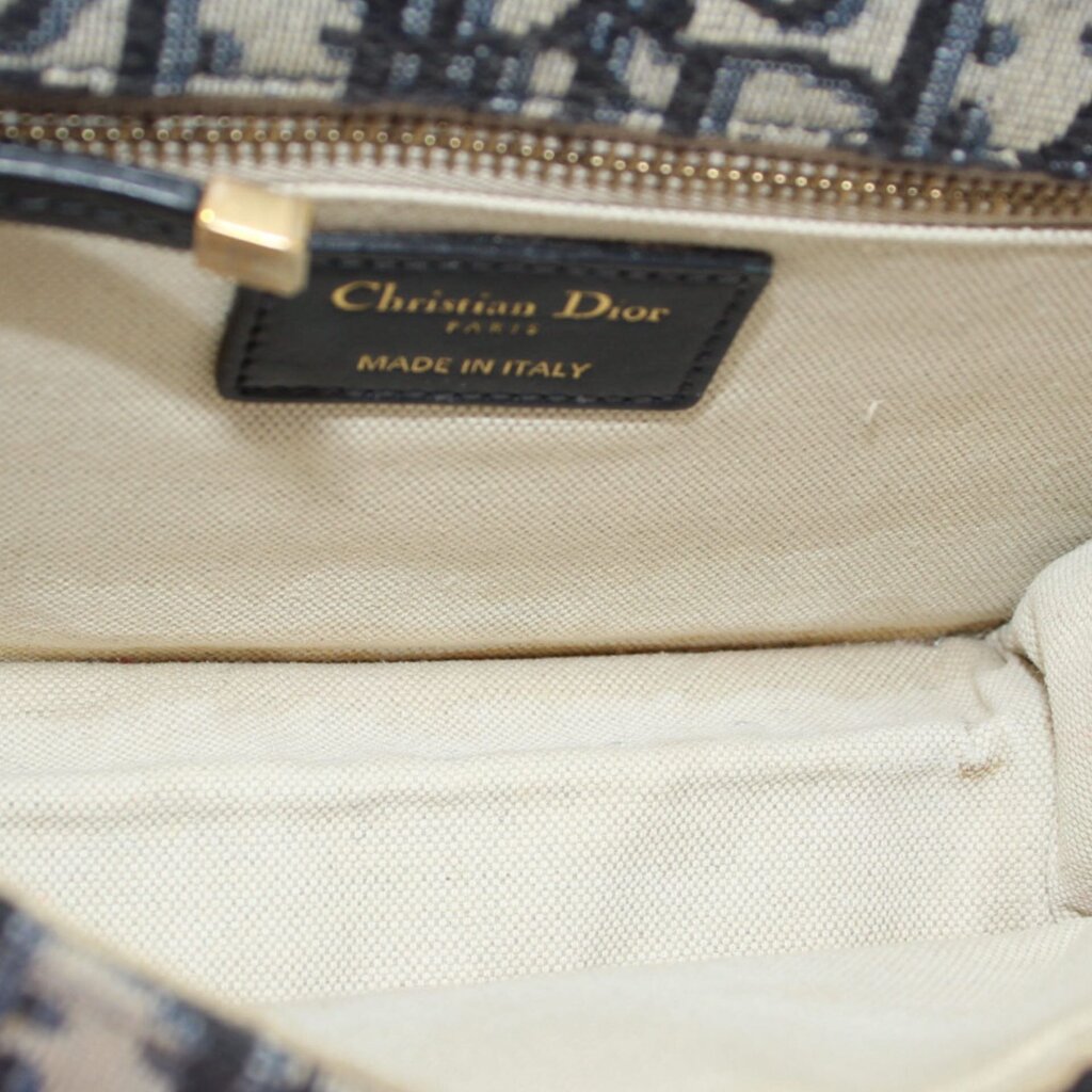 Logo patch inside flap crossbody bag lining with gold zipper pull